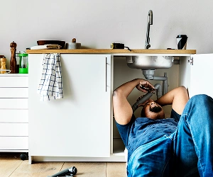 Plumber Fixing Kitchen Sink Drain Pipes In Southwest Florida